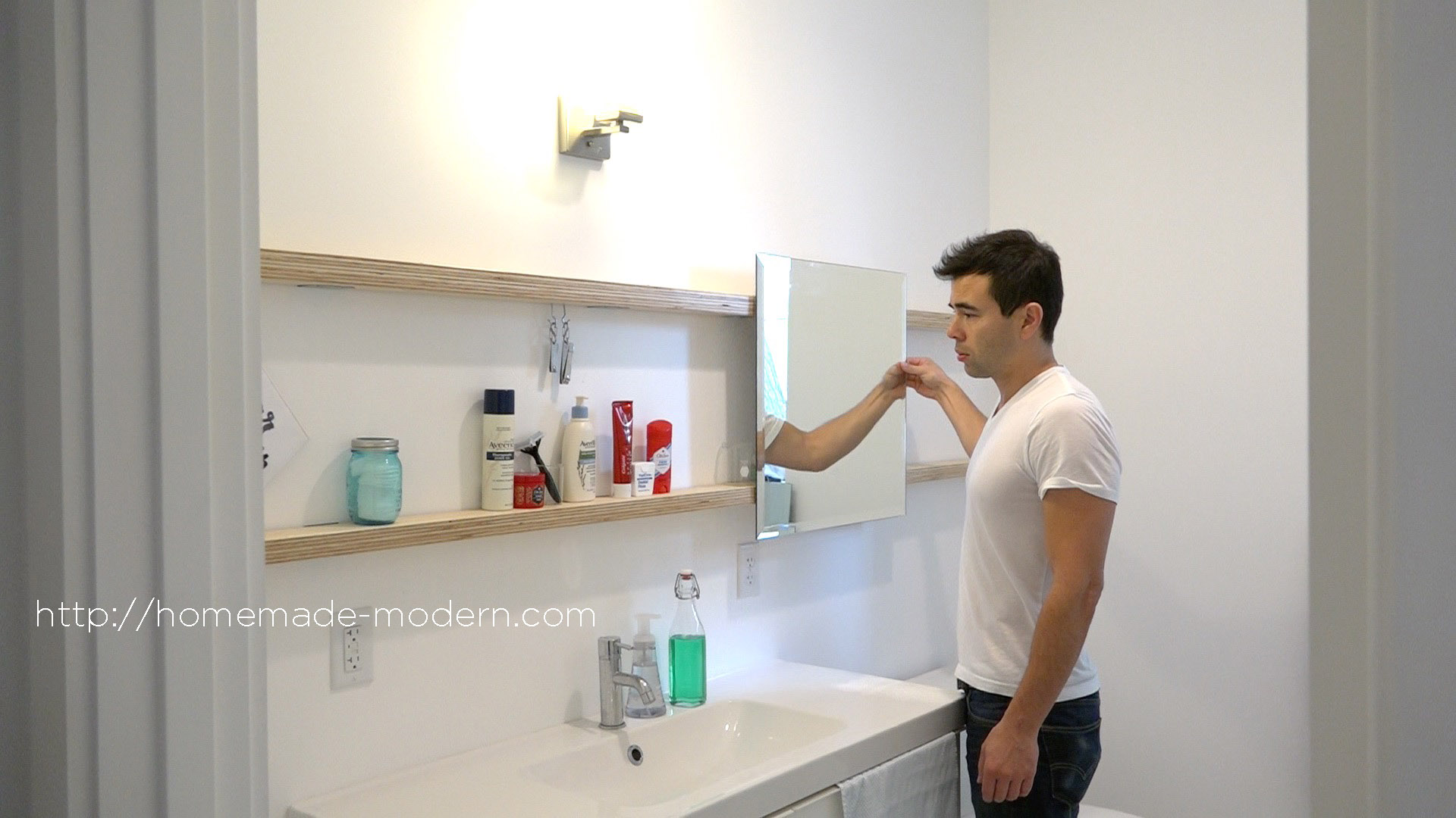 This bathroom mirror features DIY hardware that slides on plywood shelves. Full instructions can be found at HomeMade-Modern.com