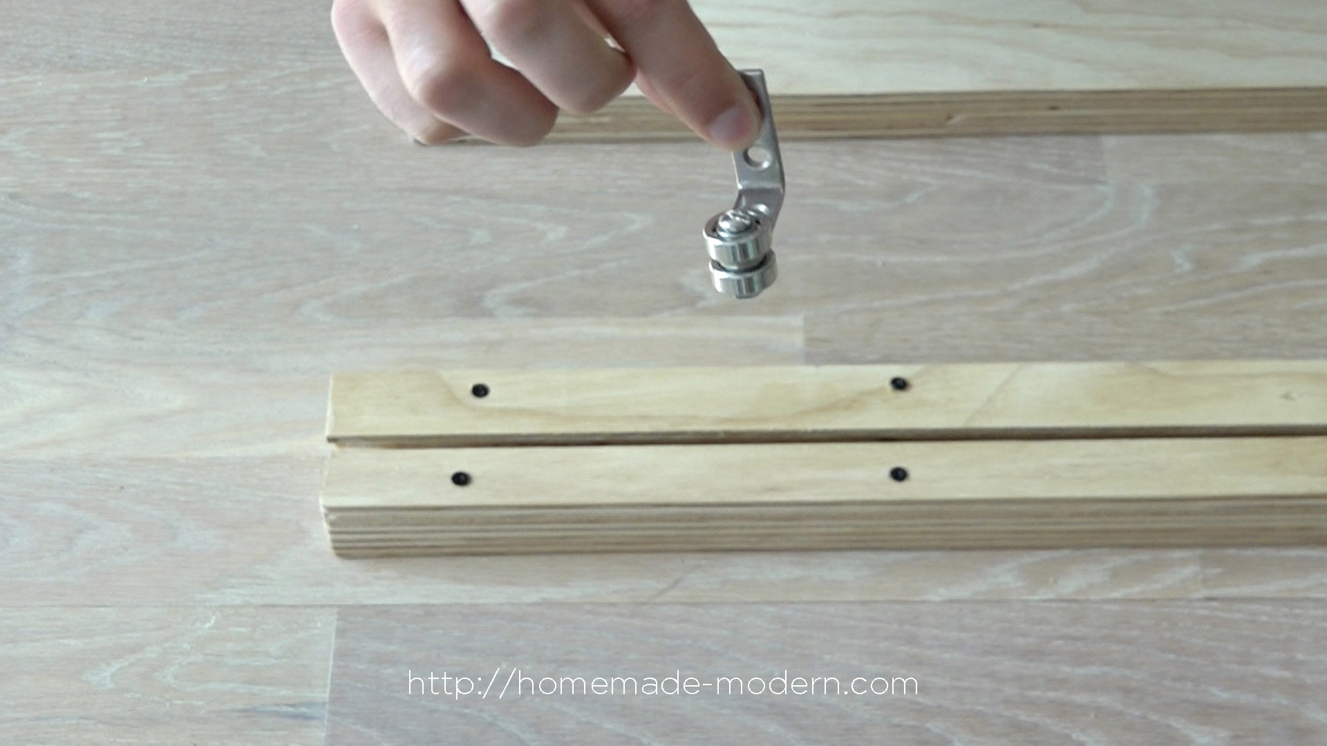 This bathroom mirror features DIY hardware that slides on plywood shelves. Full instructions can be found at HomeMade-Modern.com