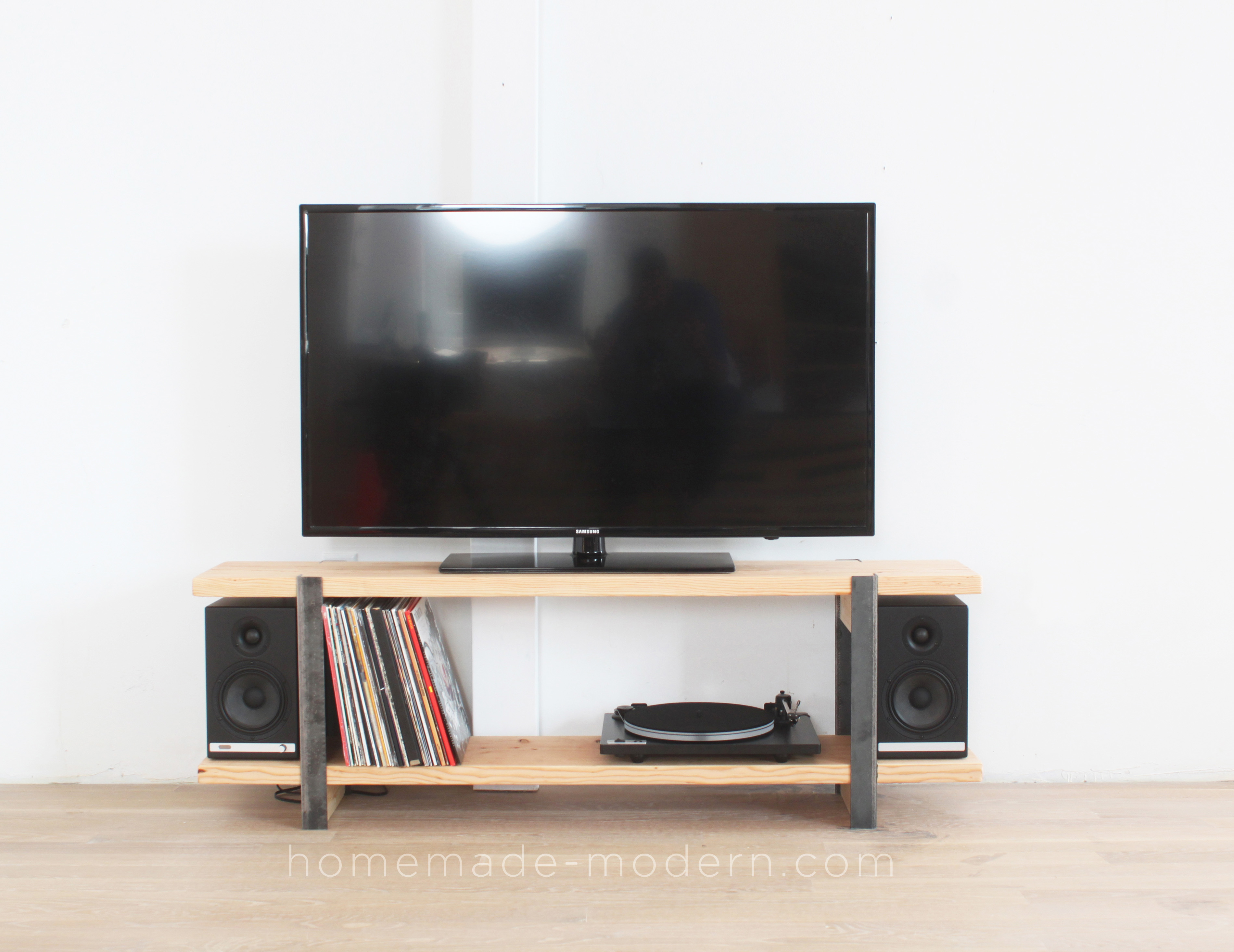 This DIY Media Console is made out of 2x12 and angle irons and the shelves were designed to store vinyl records. For more information go to HomeMade-Modern.com