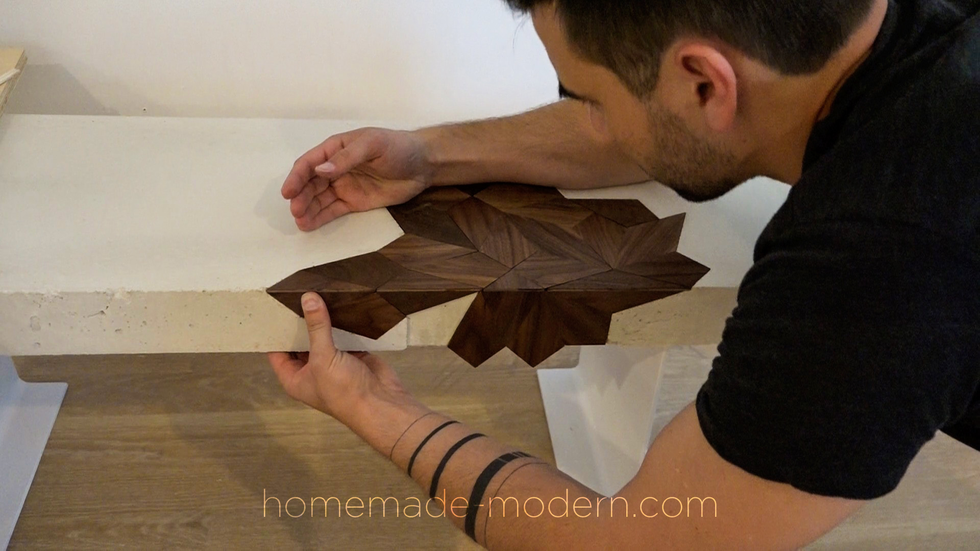 This white concrete table has a laser cut walnut inlay and was designed by Ben Uyeda. For more information go to HomeMade-Modern.com