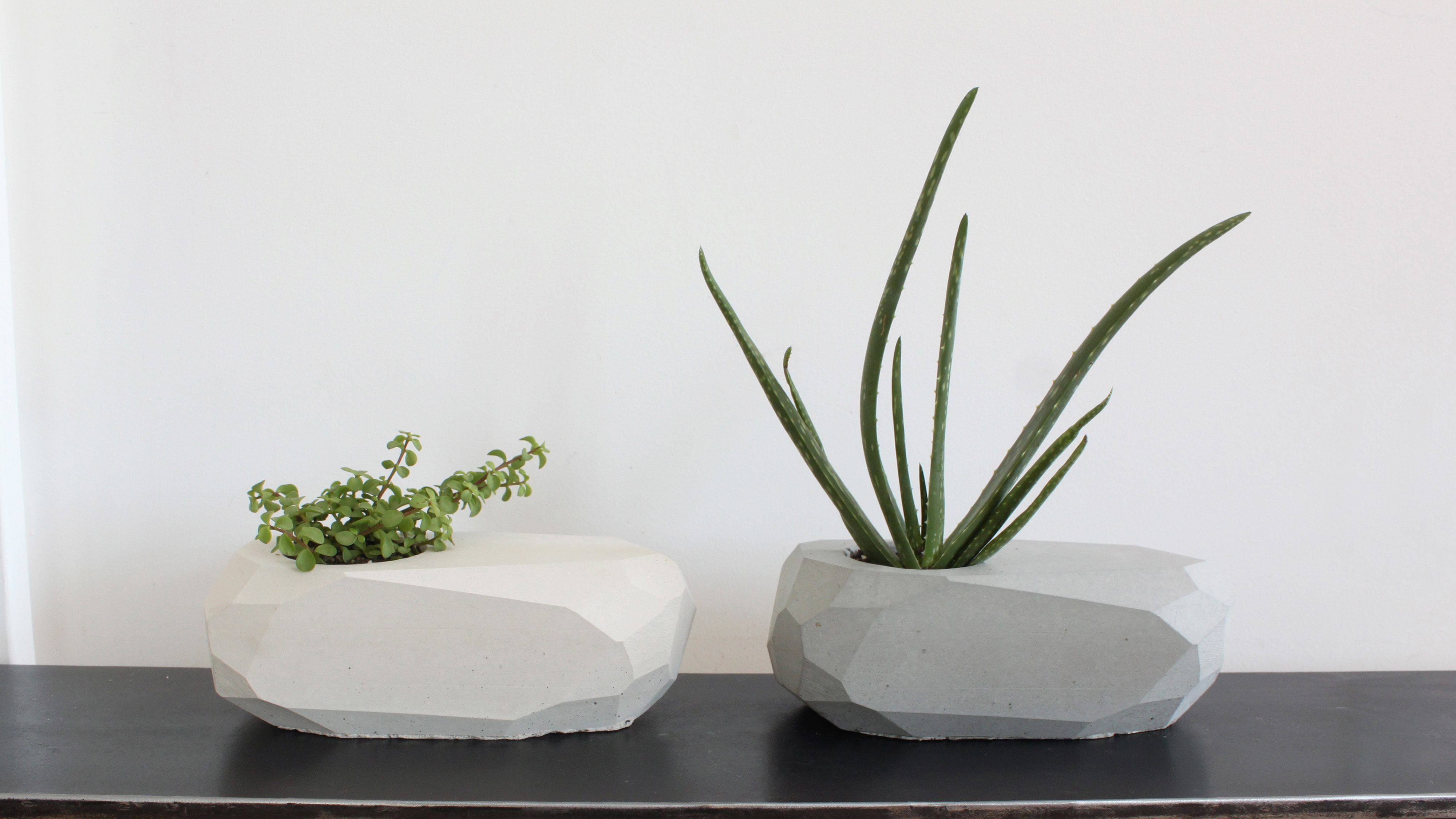 These geometric planters were cast out of concrete using reusable molds made out of silicone. For more information on this project and on DIY concrete countertops go to HomeMade-Modern.com