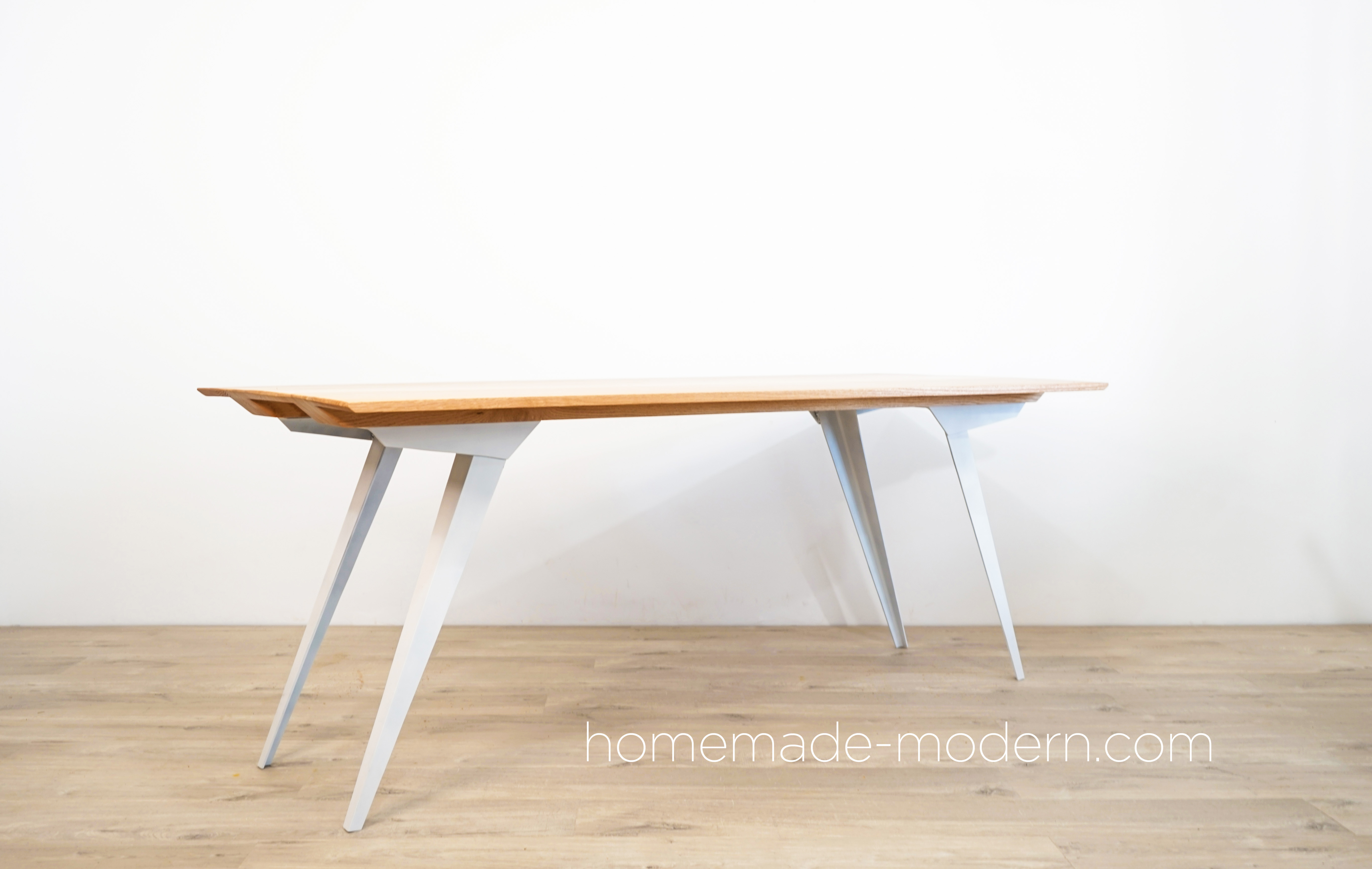 This DIY modern dining table features custom steel table legs that made out of 3”x3”x3/16” steel angles and an oak table top made out of ¾” thick oak from Home Depot. For more information go to HomeMade-Modern.com