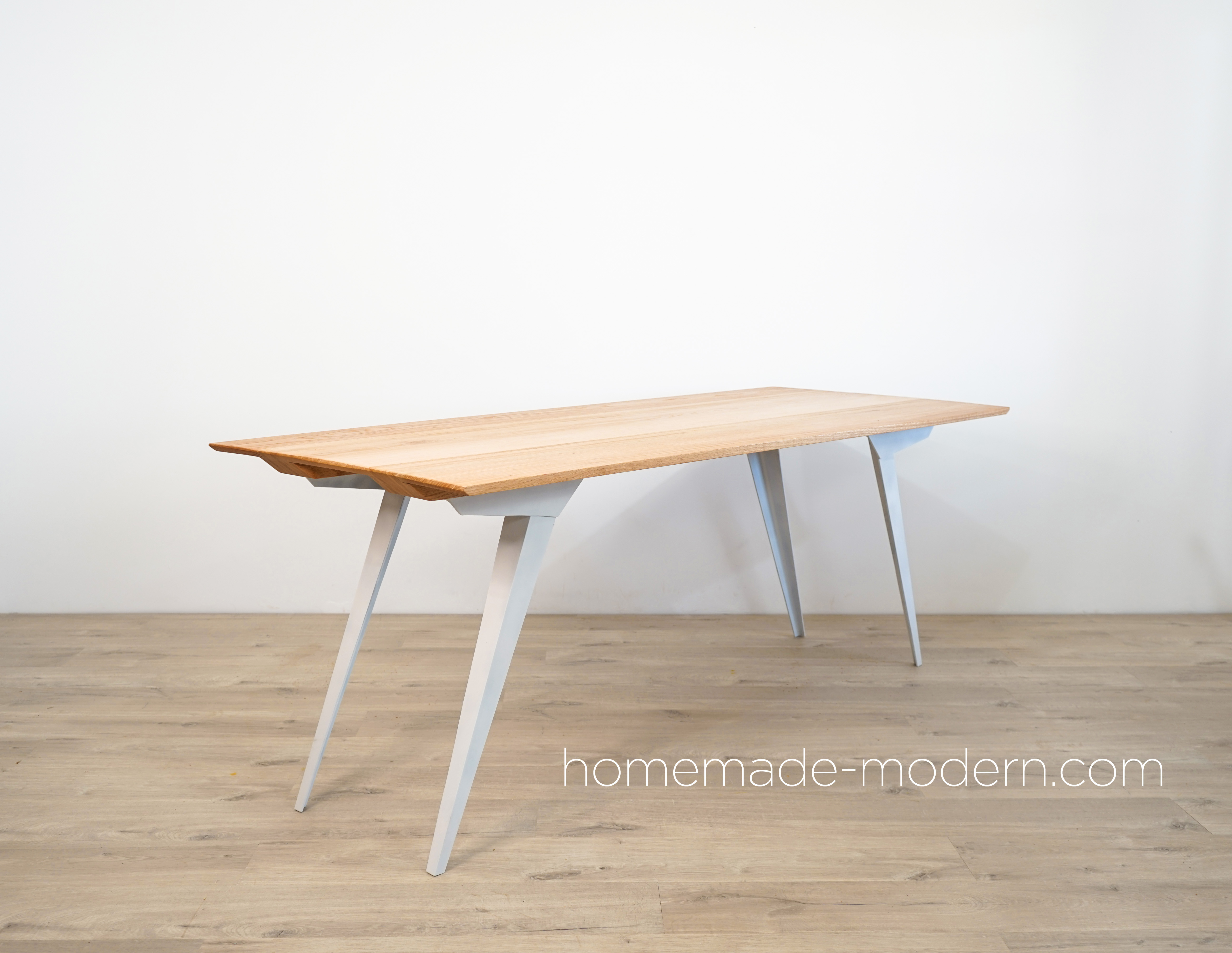 This DIY modern dining table features custom steel table legs that made out of 3”x3”x3/16” steel angles and an oak table top made out of ¾” thick oak from Home Depot. For more information go to HomeMade-Modern.com