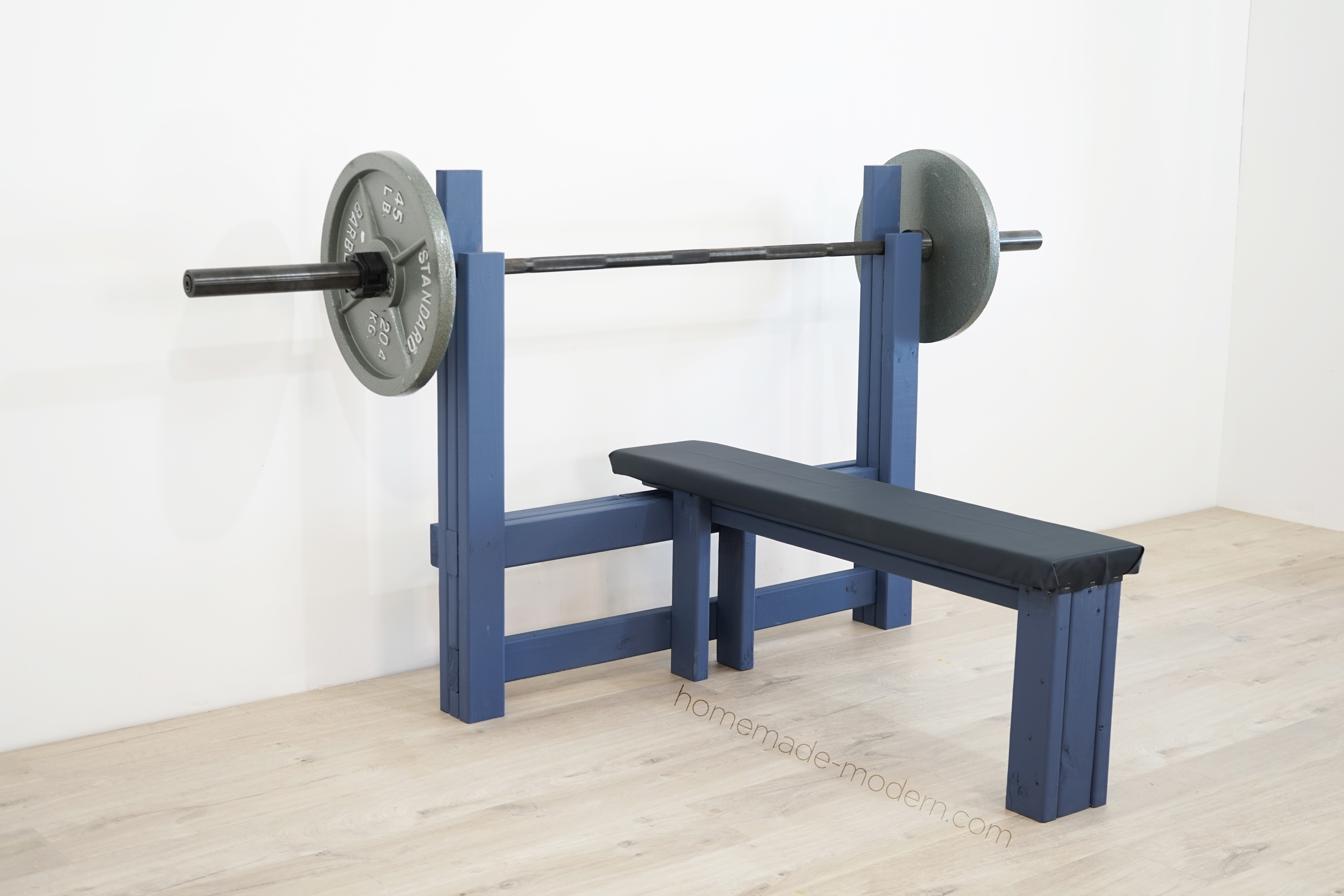 This DIY weight bench is made out  of 2x4s, some ¾” plywood, and some foam and fabric and is  designed for bench pressing. For more information go to HomeMade-Modern.com