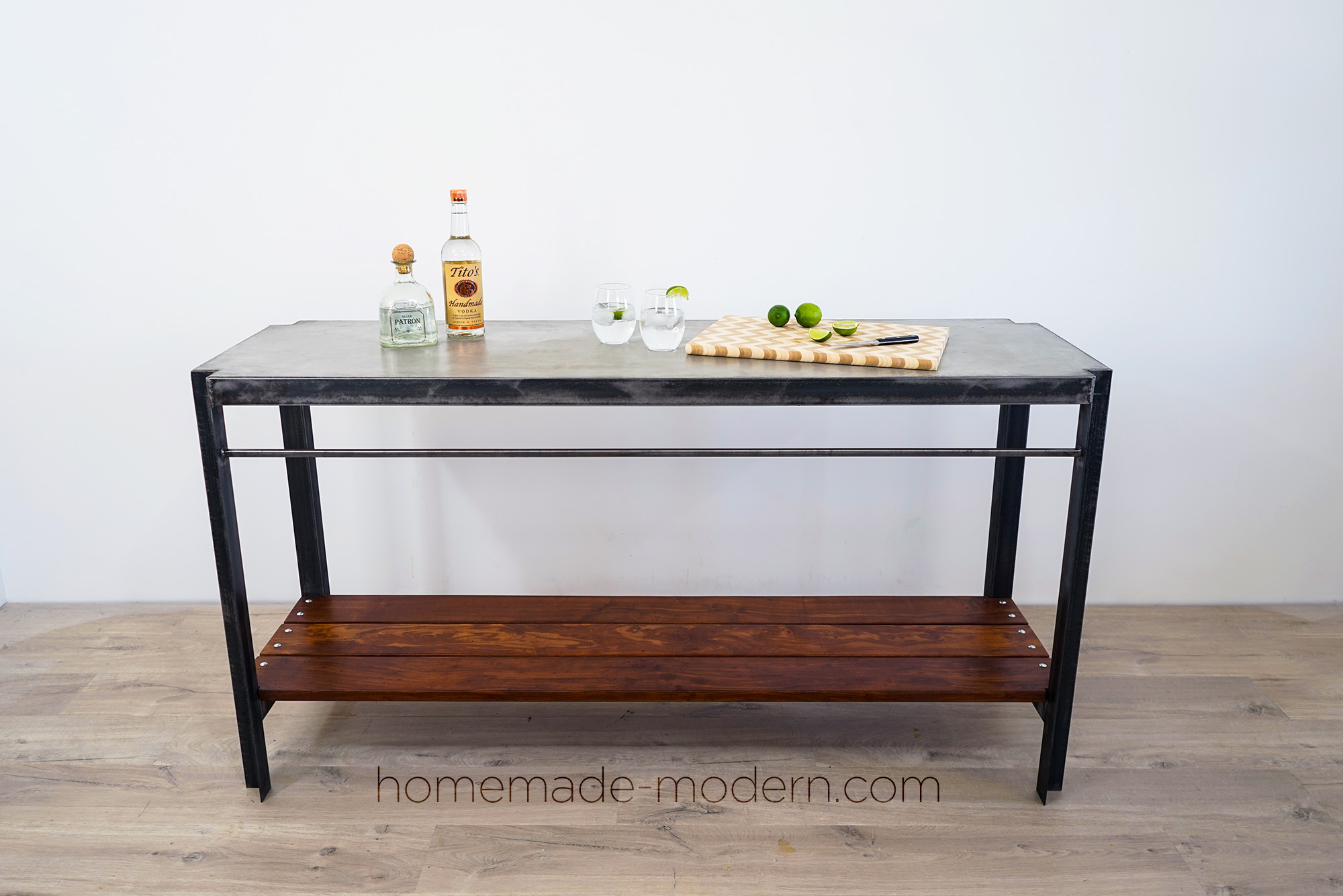 This DIY Outdoor Bar features a poured in place concrete countertop and wood shelves made out of Cumaru. For more information go to HomeMade-Modern.com